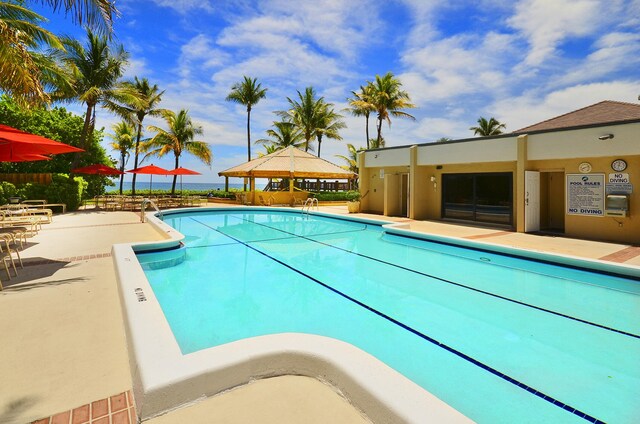3400 S Ocean Blvd Unit 4H, Highland Beach, FL 33487 - community pool featuring a gazebo and a patio area