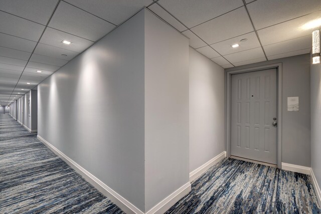 3400 S Ocean Blvd Unit 4H, Highland Beach, FL 33487 - hallway with a paneled ceiling, baseboards, and dark carpet