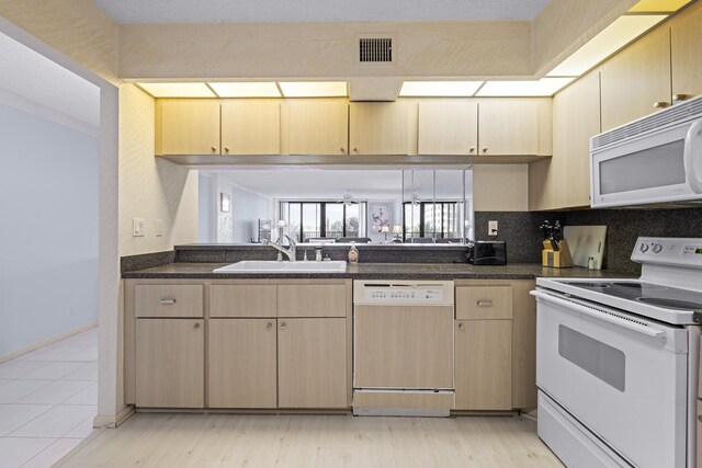 3400 S Ocean Blvd Unit 4H, Highland Beach, FL 33487 - kitchen featuring white appliances, a sink, light brown cabinetry, backsplash, and baseboards