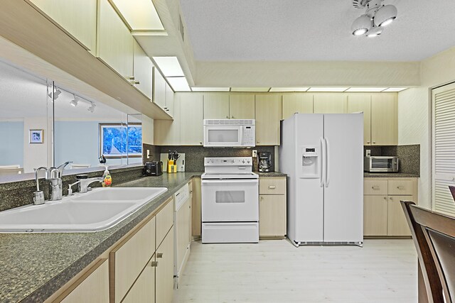 3400 S Ocean Blvd Unit 4H, Highland Beach, FL 33487 - kitchen with white appliances, a sink, dark countertops, tasteful backsplash, and light wood finished floors