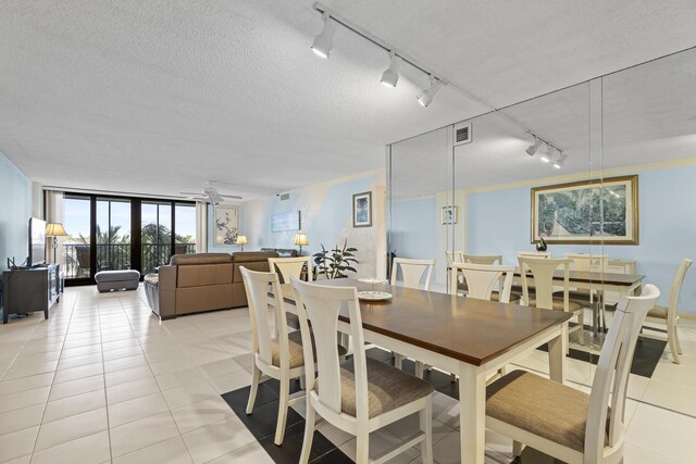 3400 S Ocean Blvd Unit 4H, Highland Beach, FL 33487 - dining space with track lighting, floor to ceiling windows, light tile patterned floors, and ceiling fan