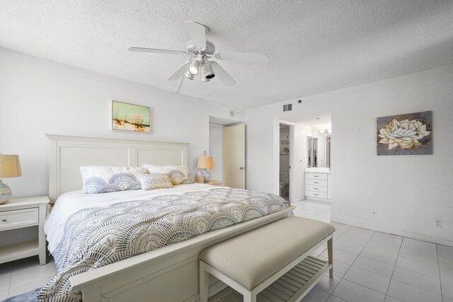 3400 S Ocean Blvd Unit 4H, Highland Beach, FL 33487 - bedroom with tile patterned floors, a textured ceiling, ceiling fan, and connected bathroom