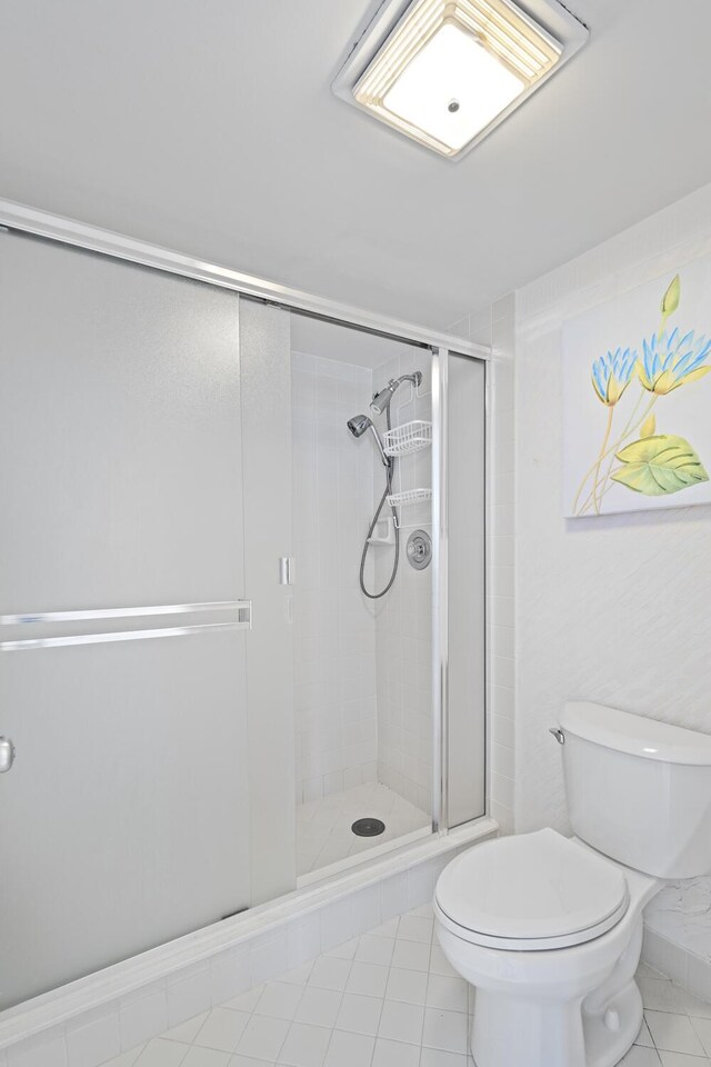 3400 S Ocean Blvd Unit 4H, Highland Beach, FL 33487 - bathroom with tile patterned flooring, toilet, and a shower stall