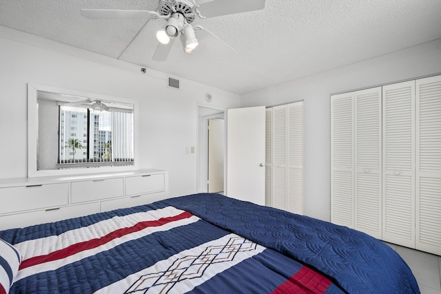 3400 S Ocean Blvd Unit 4H, Highland Beach, FL 33487 - bedroom with a textured ceiling, two closets, and ceiling fan