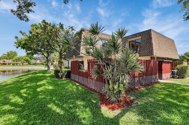 2883 SW 22nd Cir E Unit 51A, Delray Beach, FL 33445 - view of side of property with mansard roof, a balcony, a shingled roof, and a water view