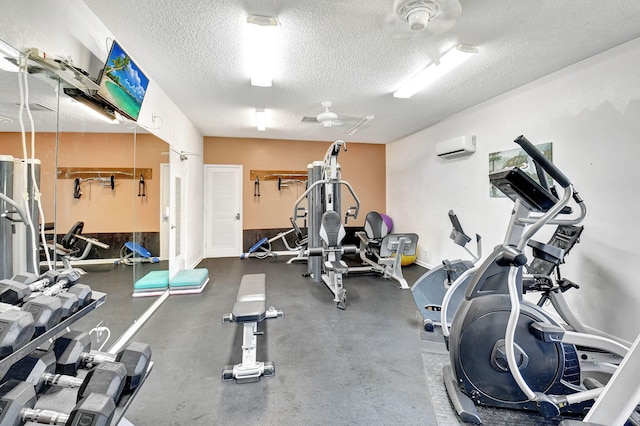 2883 SW 22nd Cir E Unit 51A, Delray Beach, FL 33445 - exercise room featuring a textured ceiling, a wall mounted AC, and a ceiling fan