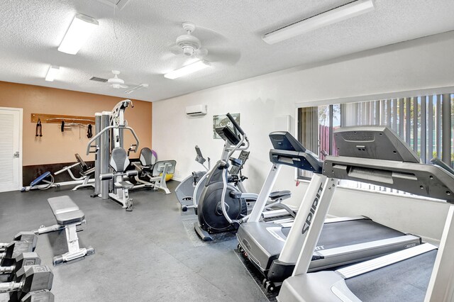 2883 SW 22nd Cir E Unit 51A, Delray Beach, FL 33445 - exercise room featuring a textured ceiling, a wall mounted AC, and ceiling fan