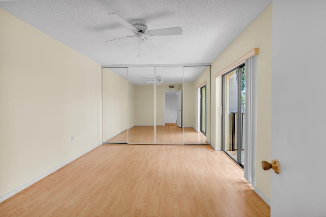 2883 SW 22nd Cir E Unit 51A, Delray Beach, FL 33445 - unfurnished bedroom featuring light wood finished floors, a textured ceiling, baseboards, and a ceiling fan