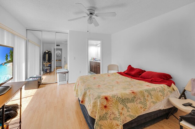2883 SW 22nd Cir E Unit 51A, Delray Beach, FL 33445 - bedroom with wood finished floors, a ceiling fan, ensuite bath, a textured ceiling, and a closet
