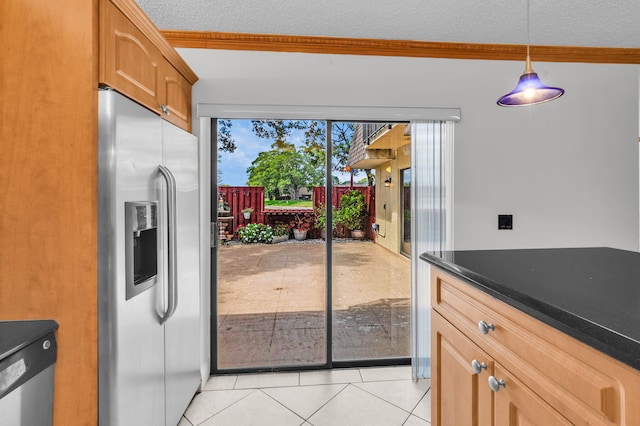 2883 SW 22nd Cir E Unit 51A, Delray Beach, FL 33445 - kitchen with stainless steel fridge with ice dispenser, light tile patterned floors, crown molding, a textured ceiling, and dark countertops