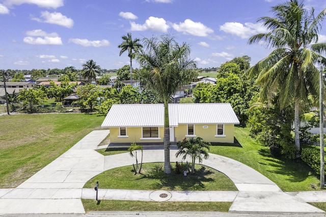 1332 SW G, Belle Glade, FL 33430 - ranch-style house with stucco siding, a front yard, metal roof, and curved driveway