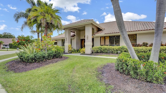 7245 Montrico Dr, Boca Raton, FL 33433 - view of front of property featuring stucco siding, a tile roof, and a front lawn