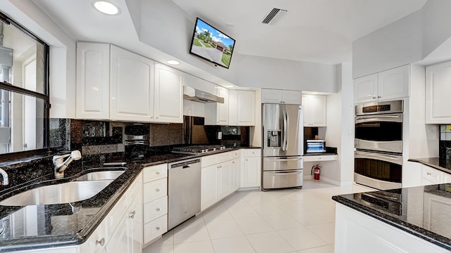 7245 Montrico Dr, Boca Raton, FL 33433 - kitchen with stainless steel appliances, a sink, dark stone counters, and backsplash