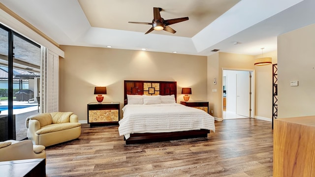 7245 Montrico Dr, Boca Raton, FL 33433 - bedroom featuring access to exterior, a raised ceiling, wood finished floors, baseboards, and recessed lighting