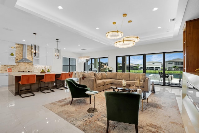 17112 Aquavera Way, Boca Raton, FL 33496 - living area featuring a chandelier, recessed lighting, light marble finish flooring, and a tray ceiling