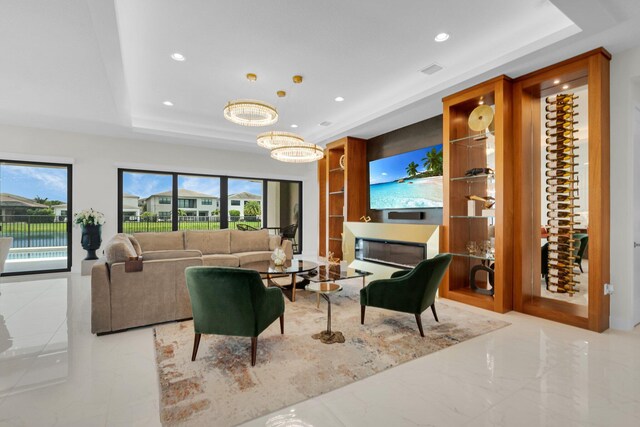17112 Aquavera Way, Boca Raton, FL 33496 - living area with a tray ceiling, recessed lighting, and a chandelier
