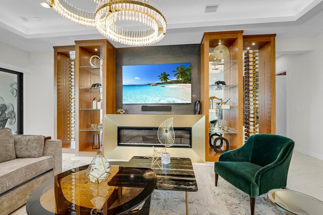 17112 Aquavera Way, Boca Raton, FL 33496 - living room featuring a chandelier, a tray ceiling, and baseboards