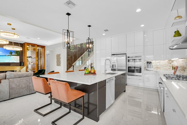 17112 Aquavera Way, Boca Raton, FL 33496 - kitchen featuring modern cabinets, appliances with stainless steel finishes, a sink, a chandelier, and light marble finish floors