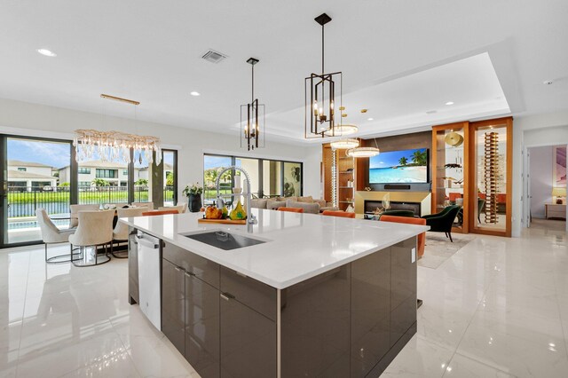 17112 Aquavera Way, Boca Raton, FL 33496 - kitchen with a sink, modern cabinets, open floor plan, a tray ceiling, and a large island