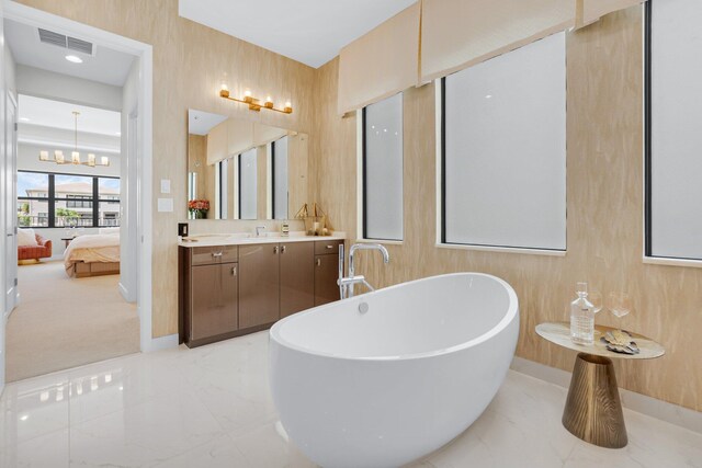 17112 Aquavera Way, Boca Raton, FL 33496 - ensuite bathroom with a freestanding bath, marble finish floors, vanity, a chandelier, and baseboards