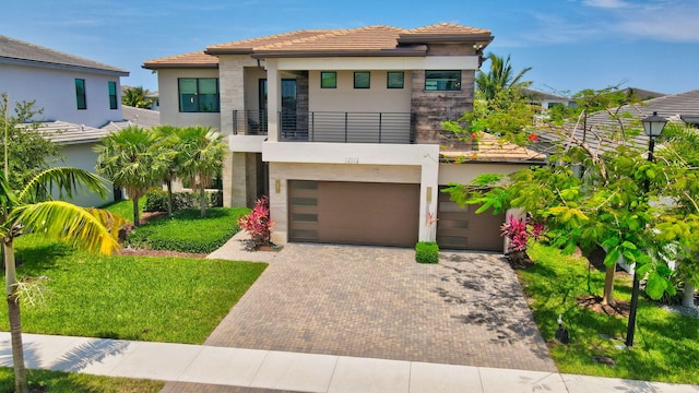 17112 Aquavera Way, Boca Raton, FL 33496 - view of front of house with a balcony, stucco siding, decorative driveway, a garage, and a tile roof