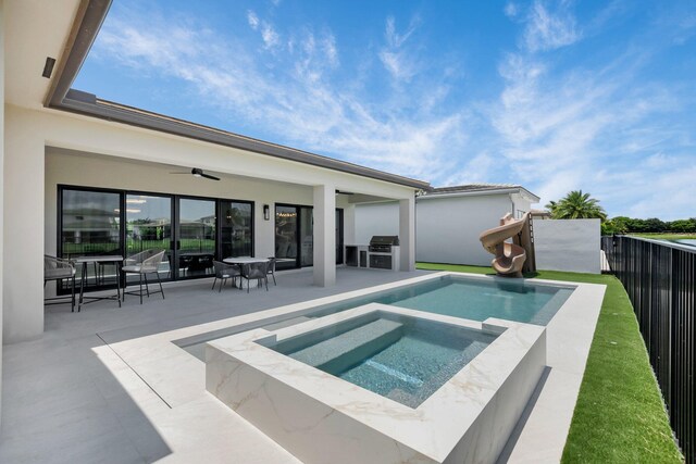 17112 Aquavera Way, Boca Raton, FL 33496 - view of swimming pool with ceiling fan, a patio area, an in-ground hot tub, a water slide, and outdoor dining area