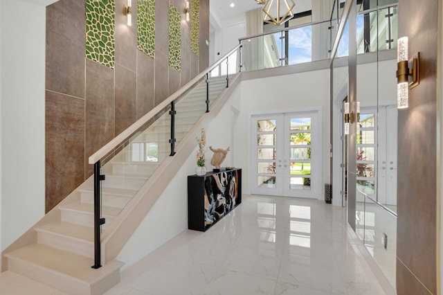 17112 Aquavera Way, Boca Raton, FL 33496 - staircase featuring a towering ceiling, french doors, marble tiled floors, and a chandelier