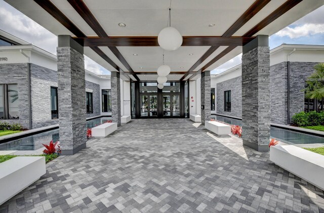 17112 Aquavera Way, Boca Raton, FL 33496 - view of property's community with beamed ceiling, decorative columns, a fireplace, and french doors