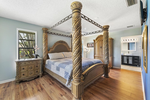 6166 Brandon St, Palm Beach Gardens, FL 33418 - bedroom with wood finished floors, a textured ceiling, and baseboards