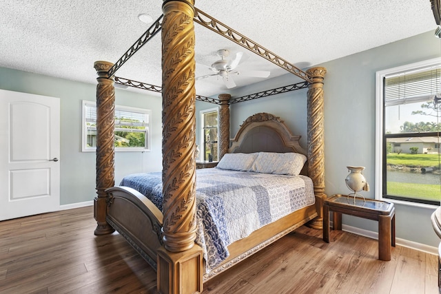 6166 Brandon St, Palm Beach Gardens, FL 33418 - bedroom with a textured ceiling, baseboards, wood finished floors, and a ceiling fan