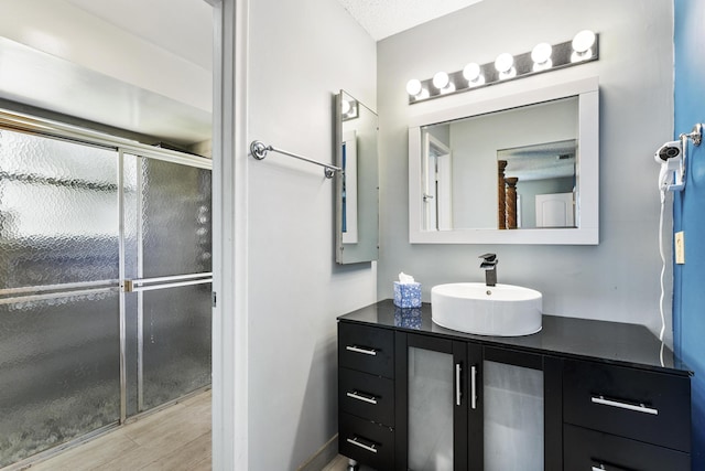 6166 Brandon St, Palm Beach Gardens, FL 33418 - full bathroom featuring vanity, a shower with door, and wood finished floors