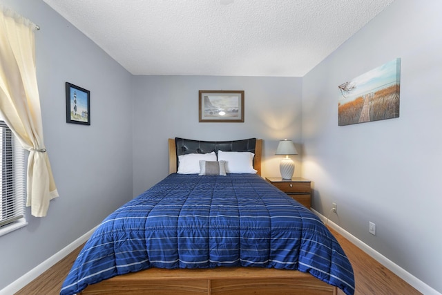 6166 Brandon St, Palm Beach Gardens, FL 33418 - bedroom featuring baseboards, wood finished floors, and a textured ceiling