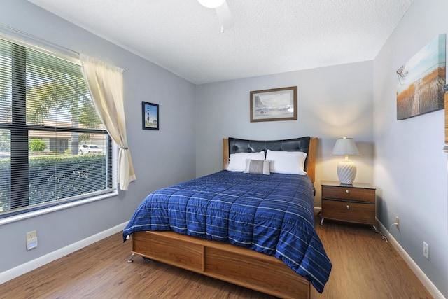 6166 Brandon St, Palm Beach Gardens, FL 33418 - bedroom featuring wood finished floors, baseboards, and a textured ceiling