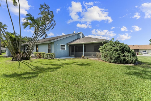 6166 Brandon St, Palm Beach Gardens, FL 33418 - rear view of house featuring a sunroom, stucco siding, a yard, and a shingled roof