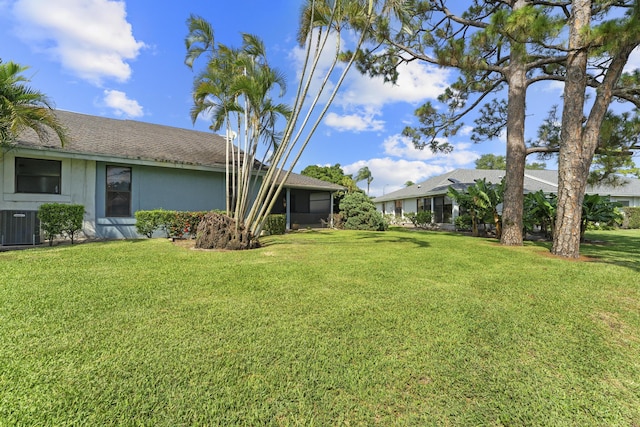 6166 Brandon St, Palm Beach Gardens, FL 33418 - view of grassy yard featuring cooling unit