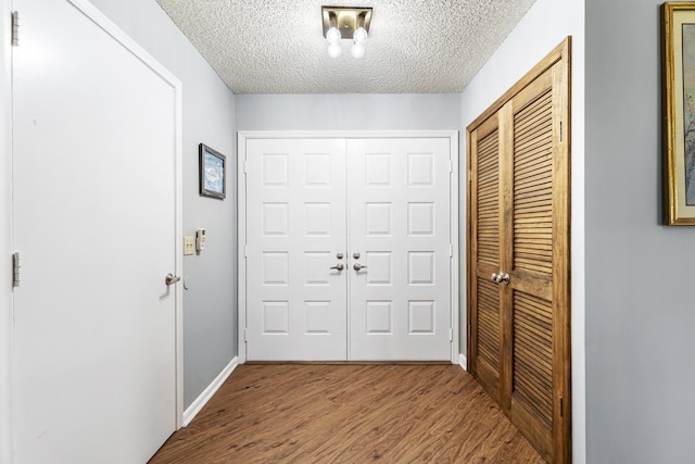 6166 Brandon St, Palm Beach Gardens, FL 33418 - hall with a textured ceiling, wood finished floors, and baseboards