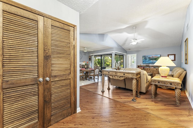 6166 Brandon St, Palm Beach Gardens, FL 33418 - living area featuring a ceiling fan, light wood-style flooring, a textured ceiling, and lofted ceiling