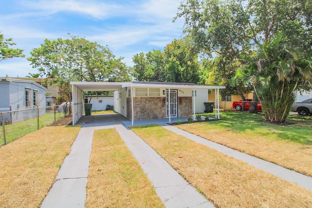 14215 NW 22nd Ct, Opa-Locka, FL 33054 - view of front of home with concrete driveway, a carport, and stone siding