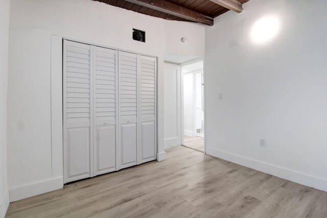 14215 NW 22nd Ct, Opa-Locka, FL 33054 - unfurnished bedroom with wood ceiling with exposed beams, light wood-type flooring, a closet, and baseboards