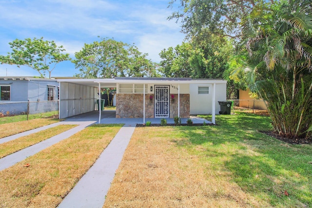 14215 NW 22nd Ct, Opa-Locka, FL 33054 - view of front of home featuring stone siding, a carport, and driveway