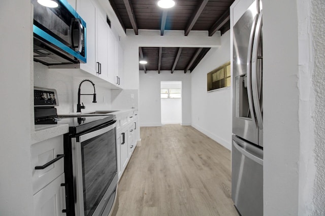 14215 NW 22nd Ct, Opa-Locka, FL 33054 - kitchen featuring stainless steel appliances, a sink, light wood-style floors, light countertops, and white cabinetry