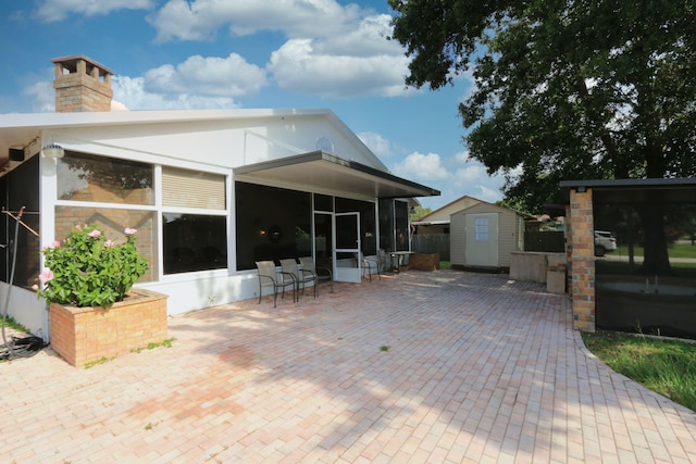 4811 Seagrape Dr, Fort Pierce, FL 34982 - rear view of house with a sunroom, a patio area, and a chimney