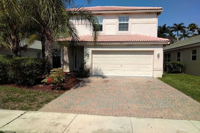 4097 Bluff Harbor Way, Wellington, FL 33449 - mediterranean / spanish-style home with decorative driveway, a garage, stucco siding, and a tiled roof