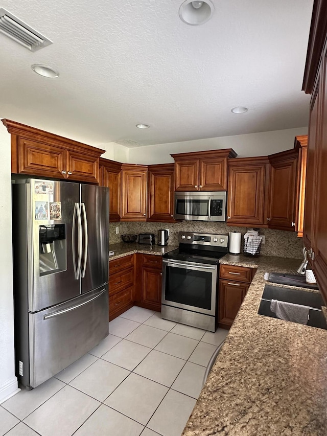 4097 Bluff Harbor Way, Wellington, FL 33449 - kitchen featuring stainless steel appliances, a sink, light tile patterned flooring, decorative backsplash, and recessed lighting