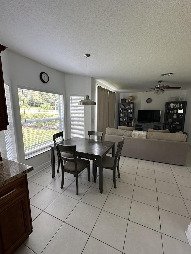 4097 Bluff Harbor Way, Wellington, FL 33449 - dining space featuring a ceiling fan, a textured ceiling, and light tile patterned floors