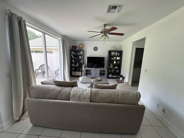 4097 Bluff Harbor Way, Wellington, FL 33449 - living area with a ceiling fan, light tile patterned flooring, baseboards, and a textured ceiling