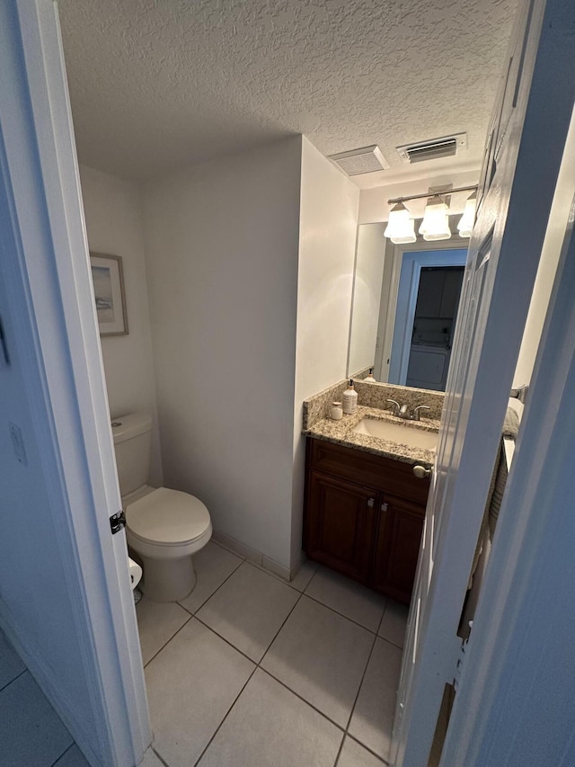 4097 Bluff Harbor Way, Wellington, FL 33449 - half bath featuring toilet, vanity, tile patterned floors, and a textured ceiling