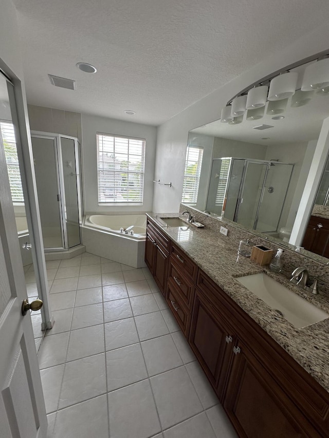 4097 Bluff Harbor Way, Wellington, FL 33449 - full bathroom featuring a stall shower, double vanity, a bath, and a textured ceiling