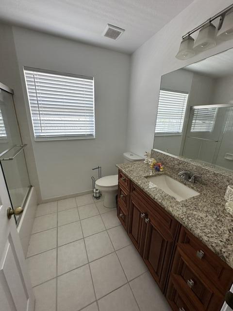 4097 Bluff Harbor Way, Wellington, FL 33449 - full bath featuring tile patterned floors, vanity, plenty of natural light, and toilet