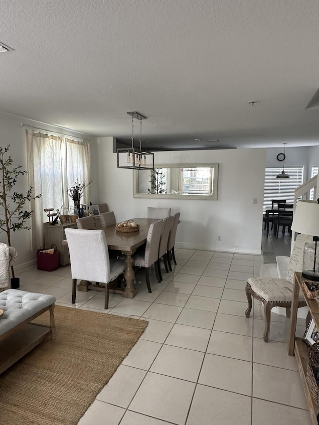 4097 Bluff Harbor Way, Wellington, FL 33449 - dining area featuring plenty of natural light, light tile patterned floors, a textured ceiling, and baseboards